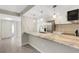 Bright kitchen with stainless appliances, granite counters, pendant lights, and an open view to living area at 2319 Beneva Ter # 2284, Sarasota, FL 34232