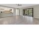 Tile flooring in open living area with view of modern kitchen and sliding glass doors to lanai at 2319 Beneva Ter # 2284, Sarasota, FL 34232