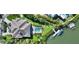 Overhead view of home featuring a backyard pool, lush lawn, and private boat dock at 244 Cedar Park Cir, Sarasota, FL 34242