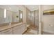 Bathroom with a double vanity, step-in shower, and bright lighting at 244 Cedar Park Cir, Sarasota, FL 34242