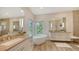 Luxurious bathroom featuring dual vanities, a standalone tub, and a window with a view at 244 Cedar Park Cir, Sarasota, FL 34242