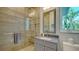 Bathroom with stone shower enclosure, large vanity and tropical views at 244 Cedar Park Cir, Sarasota, FL 34242