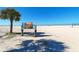 Expansive white sand beach featuring a Siesta Beach sign and a volleyball net under a clear blue sky at 244 Cedar Park Cir, Sarasota, FL 34242