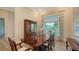 Refined dining room with a large wooden table, elegant chairs, and ample natural light at 244 Cedar Park Cir, Sarasota, FL 34242