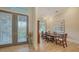 Elegant dining room featuring beautiful doors, stylish furniture, and a decorative vase at 244 Cedar Park Cir, Sarasota, FL 34242