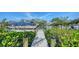 Private dock with a covered boat and lush green landscaping, perfect for boating enthusiasts at 244 Cedar Park Cir, Sarasota, FL 34242