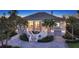 Elegant home exterior with a curved staircase and lush landscaping, providing exceptional curb appeal at 244 Cedar Park Cir, Sarasota, FL 34242