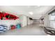 Spacious three car garage with painted floors, window, and ample storage space for water equipment at 244 Cedar Park Cir, Sarasota, FL 34242