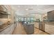 Modern kitchen with stainless steel appliances, custom cabinetry, and a center island for ample cooking and gathering space at 244 Cedar Park Cir, Sarasota, FL 34242