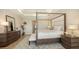 Bedroom features a four poster bed and a neutral color palette at 244 Cedar Park Cir, Sarasota, FL 34242