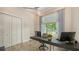Office space with a ceiling fan and a large window offering a view of tropical foliage at 244 Cedar Park Cir, Sarasota, FL 34242