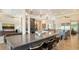 Open-concept living area showcases a modern kitchen, dining space, and cozy living room, all bathed in natural light with stylish finishes at 244 Cedar Park Cir, Sarasota, FL 34242