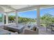 Expansive covered patio with fire pit, comfortable seating, and views of the pool and landscaped backyard at 244 Cedar Park Cir, Sarasota, FL 34242