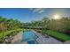 Stunning backyard with a luxurious pool, beautiful landscaping, and waterfront views at 244 Cedar Park Cir, Sarasota, FL 34242