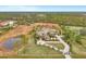 Aerial view of an expansive property with a pond, estate home, barn, and acres of green space at 24705 83Rd E Ave, Myakka City, FL 34251