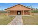 Front exterior of a barn, featuring a stone pathway leading up to its entrance at 24705 83Rd E Ave, Myakka City, FL 34251