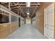 Interior of the barn featuring multiple wooden horse stalls and concrete flooring at 24705 83Rd E Ave, Myakka City, FL 34251