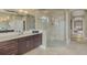 Bright bathroom features a glass shower, double vanity with modern fixtures, and a serene, spa-like atmosphere at 24705 83Rd E Ave, Myakka City, FL 34251