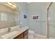 Modern bathroom boasts granite counters, wood cabinets, decorative lighting, and a glass-enclosed shower at 24705 83Rd E Ave, Myakka City, FL 34251
