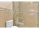 Tiled bathroom featuring a glass-enclosed shower and a modern toilet at 24705 83Rd E Ave, Myakka City, FL 34251