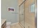 Modern bathroom with a shower featuring a sliding glass door, complemented by light-blue walls at 24705 83Rd E Ave, Myakka City, FL 34251