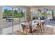 Dining room featuring a modern table, backyard views, and access to an outdoor grill area, ideal for entertaining at 24705 83Rd E Ave, Myakka City, FL 34251