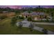 Stunning luxury property with a circular driveway, tropical plants, and a peaceful setting at dusk at 24705 83Rd E Ave, Myakka City, FL 34251