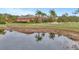 Charming single Gathering home with a pond, well maintained lawn, and mature trees at 24705 83Rd E Ave, Myakka City, FL 34251