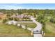 Elegant estate home with a gated entrance, circular driveway, and lush landscaping at 24705 83Rd E Ave, Myakka City, FL 34251