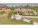 Beautiful home with a circular driveway surrounded by mature trees and manicured lawns at 24705 83Rd E Ave, Myakka City, FL 34251