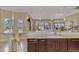 Kitchen bar with granite counters and modern lighting overlooking the outdoor living spaces at 24705 83Rd E Ave, Myakka City, FL 34251