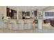 Spacious kitchen with granite counters, island with seating, modern light fixtures, and stainless steel appliances at 24705 83Rd E Ave, Myakka City, FL 34251