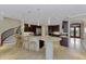Spacious kitchen with granite countertops, a breakfast bar and a spiral staircase creating an inviting, multi-level space at 24705 83Rd E Ave, Myakka City, FL 34251