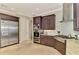 Well-equipped kitchen with stainless appliances, granite counters, and dark wood cabinets at 24705 83Rd E Ave, Myakka City, FL 34251