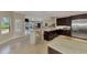Open kitchen with stainless steel appliances, breakfast bar and view into backyard with pool creating an indoor/outdoor atmosphere at 24705 83Rd E Ave, Myakka City, FL 34251