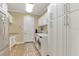 Bright laundry room with modern washer/dryer, ample storage, and utility sink at 24705 83Rd E Ave, Myakka City, FL 34251