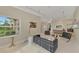Open living room with neutral tones, modern lighting, and large window views offering natural light at 24705 83Rd E Ave, Myakka City, FL 34251
