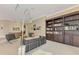 Bright living room with custom bookshelves and modern furnishings, perfect for relaxing and entertaining guests at 24705 83Rd E Ave, Myakka City, FL 34251