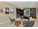Stylish living room featuring built-in bookshelves, modern seating, and ample natural light at 24705 83Rd E Ave, Myakka City, FL 34251