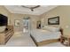 Spacious main bedroom showcasing neutral tones, a large bed, and natural light with tray ceiling at 24705 83Rd E Ave, Myakka City, FL 34251