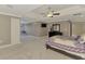 Bright main bedroom featuring tray ceilings, TV, and large closets with an adjacent sitting area at 24705 83Rd E Ave, Myakka City, FL 34251