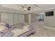 Large main bedroom with tray ceilings, TV, large closets, and a sitting area with windows at 24705 83Rd E Ave, Myakka City, FL 34251