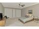 Bright, airy main bedroom featuring soft carpet, stylish furnishings, neutral decor, and double closets at 24705 83Rd E Ave, Myakka City, FL 34251