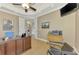 Well-lit office space featuring a wooden desk, comfortable seating, and neutral wall colors at 24705 83Rd E Ave, Myakka City, FL 34251