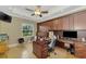 Spacious office with custom wood cabinetry, large desk, and ample natural light at 24705 83Rd E Ave, Myakka City, FL 34251