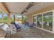 Spacious covered patio with outdoor seating and stainless steel grill, overlooking pool area at 24705 83Rd E Ave, Myakka City, FL 34251