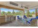Spacious screened patio with outdoor kitchen, grill, and view of pool area at 24705 83Rd E Ave, Myakka City, FL 34251