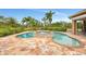 View of the pool and connected spa area, surrounded by lush landscaping and tropical plants at 24705 83Rd E Ave, Myakka City, FL 34251