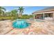 Backyard view of a private pool and spa surrounded by lush landscaping in a tropical setting at 24705 83Rd E Ave, Myakka City, FL 34251