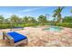Scenic view of the pool with lush landscaping and lounge chairs at 24705 83Rd E Ave, Myakka City, FL 34251